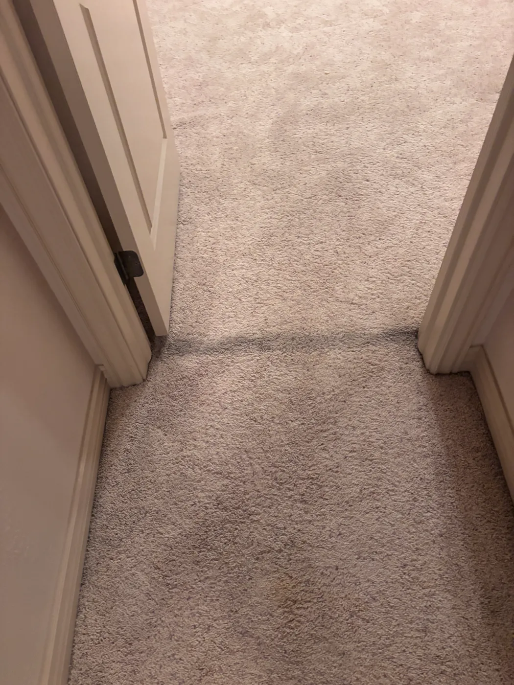 Carpet seam line at a doorway threshold on a 316 repair job