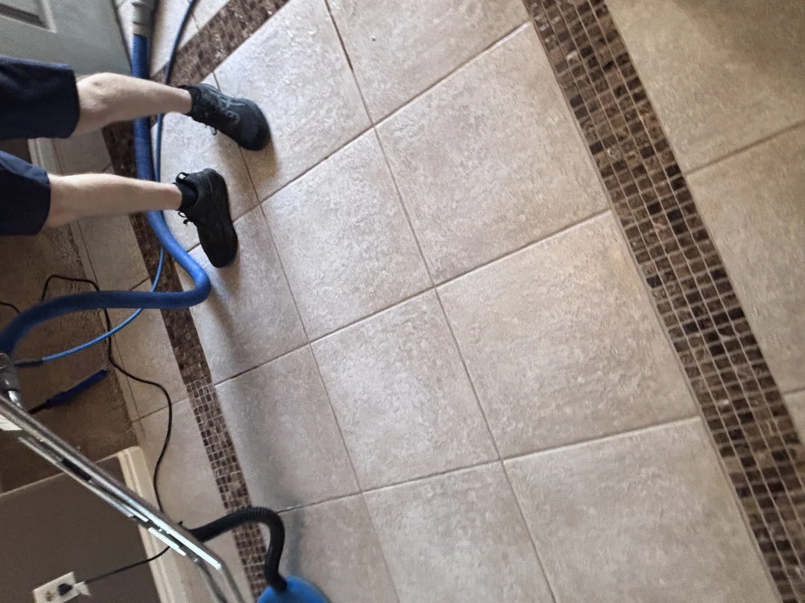Owner-shot tile and grout rinsing work on a Southern Utah tile floor